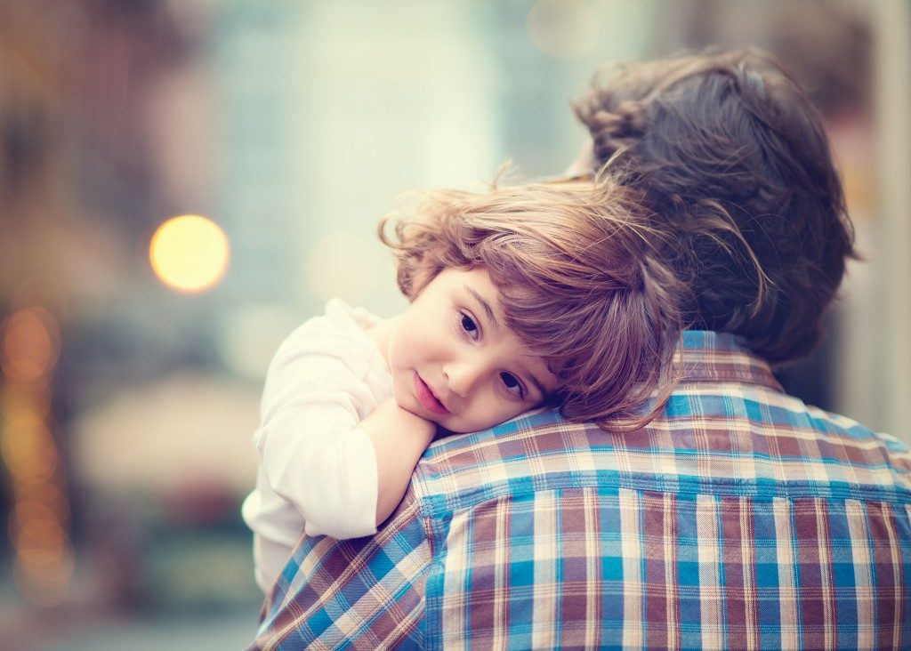 Child hugging his father