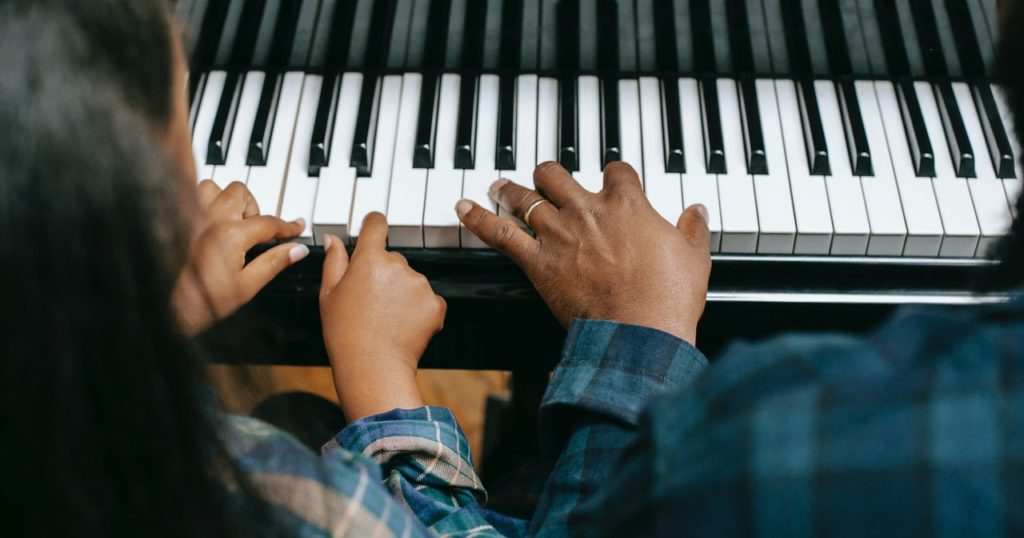 kid taking piano lessons