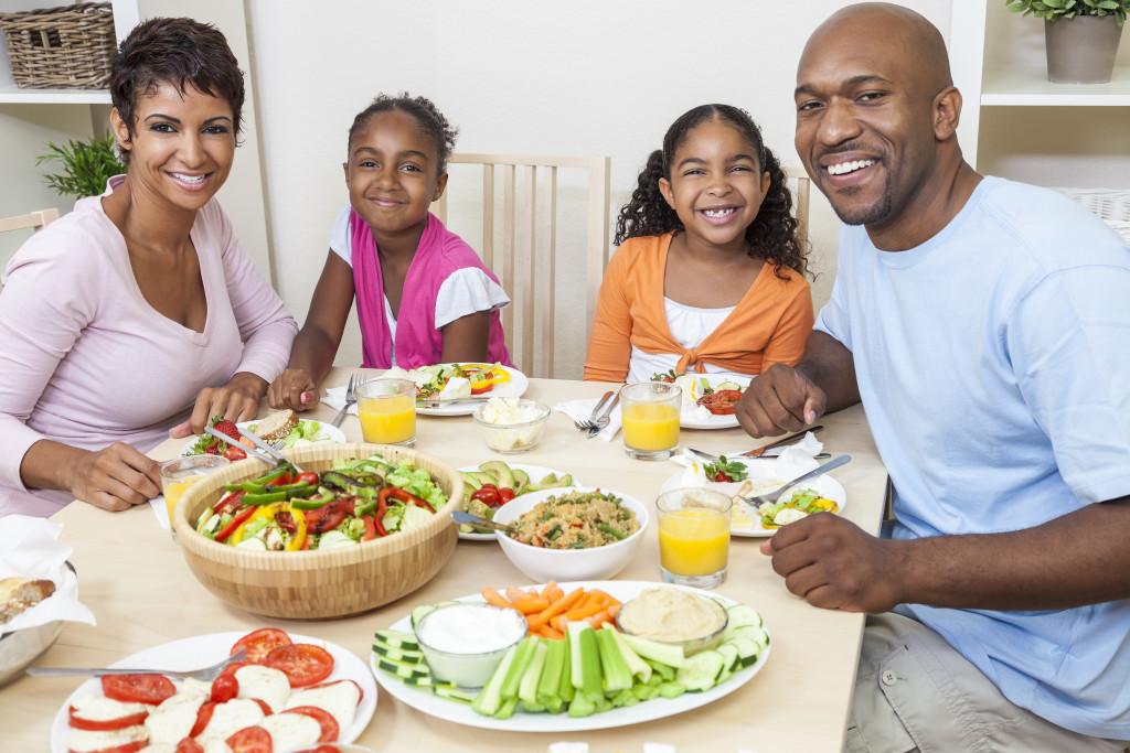 a family at the dinner table with healthy meals