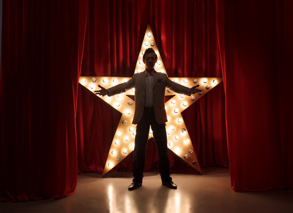 A theater actor standing in front of a star