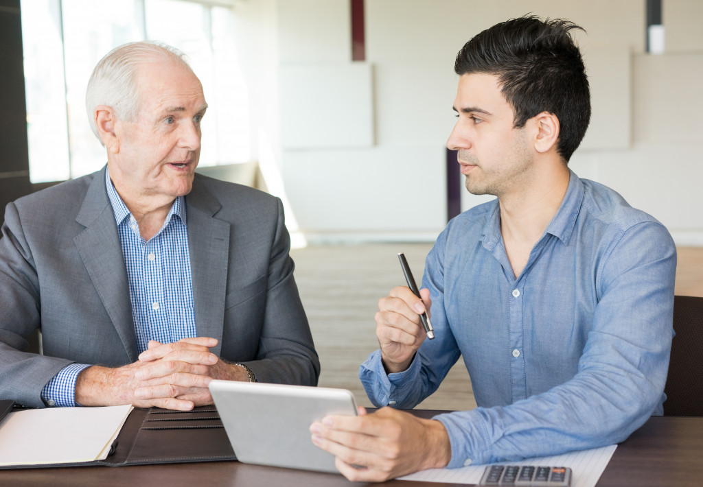 a young and senior businessmen having a discussion